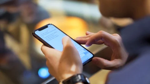 Close up of a man holding device and reading the text on the screen, modern Stock Footage 107158158