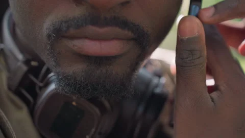 Close up man holding electronic gadgets including smartphone and headphones Stock Footage 345127092