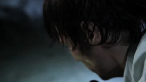 Close up of man holding flashlight in woods at night in fear 스톡 동영상 191348795