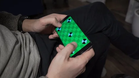 Close-up of the man Holding Green Screen Smartphone in Landscape Mode and Stock Footage 102225018