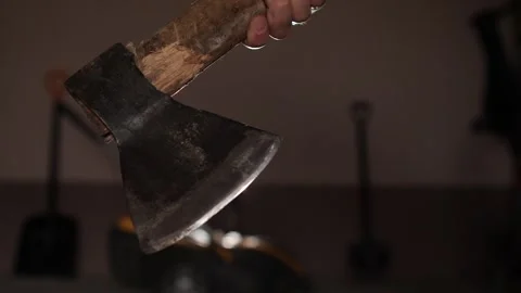 Close up of man holding old axe in garage with tools stored Stock Footage 287114236