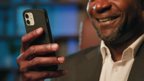 Close-up man holding phone receiving email reads good news smiling businessman Stock Footage 219822821