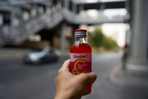 Close-up of a man holding a red refreshing drink, 31 January, 2025 Stock Photos