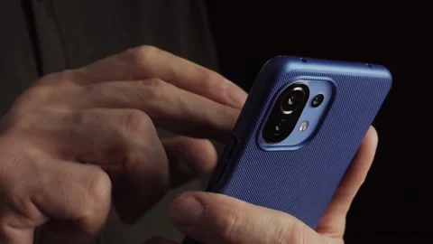Close-up of a man holding a smartphone in his hands and using an app. Stock Footage 169248903