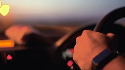 Close-up of man holding steering wheel and driving car Stock Footage 133375234
