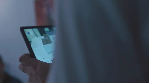 Close-up of man holding a tablet and using the home design program. Stock Video stock 101355426