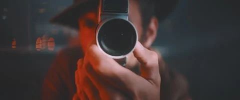 Close up of man holding vintage camera and smiling in red lights Stock Footage 203567508