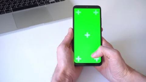 Close-up. man holds smartphone both hands scrolls and presses his finger on 库存影片 166998899