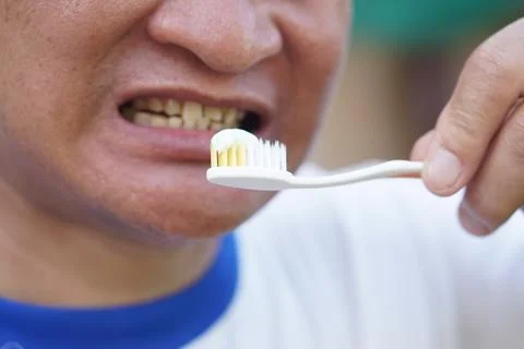 Close up man holds toothbrush with toothpaste. Concept, dental health care. Stock Photos