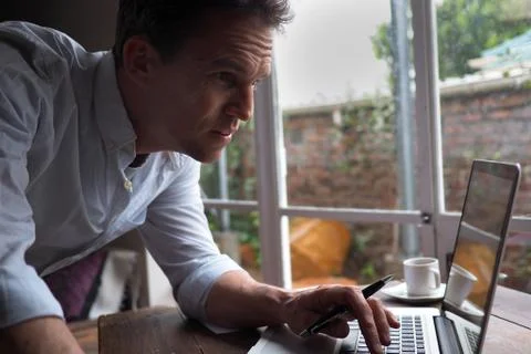 Close up of man in home office using computer. Фото
