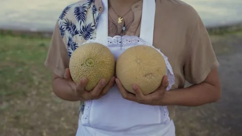 Close-up of Man Humorously Holding Two Melons 動画素材 287256752