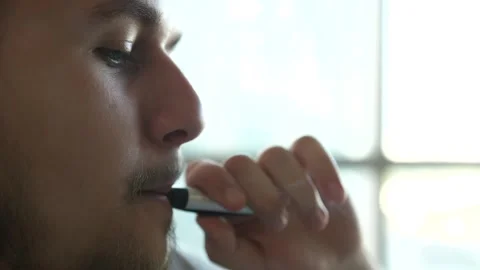 Close-up of man inhaling an e-cigarette vaping device. slow motion Stock-Footage 150152842