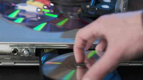 Close-up of Man Inserting Disc to DVD Player Stock Footage 169453851