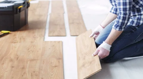 Close up of man installing wood flooring Stock Footage