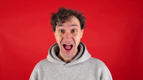 Close up man, joyfully surprised, holding face mouth open, pronouncing word wow Видео 304750294