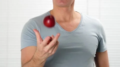 Close up man juggles red apples in studio slow motion Stock Footage 147647270