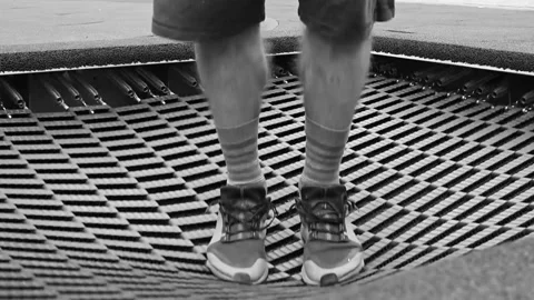 Close up of man jumping on trampoline dynamic motion Vídeo Stock 346719648
