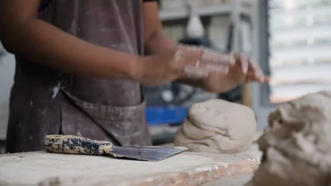 Close up of man kneading clay on table in workshop, Melaka, Malaysia Stock Footage 146563417