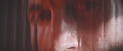 Close up of man in laser light thourgh striped glass plate Video stock 203561813