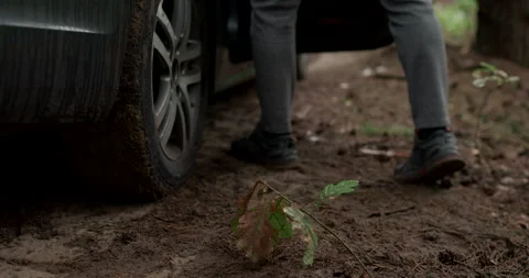 Close up of man legs next to vehicle on dirt ground with real sound Stock Footage 340848664