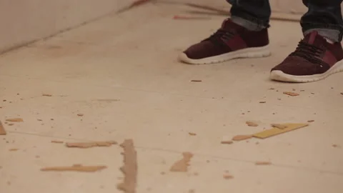 Close up of man legs sweeping up garbage with broom Stock Footage 95527559