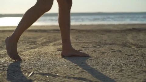 Close up man legs walking sand beach seaside sunrise rapid slow motion Stock Footage 78751277