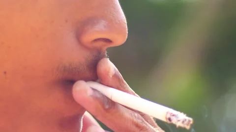 Close-up of a man lighting a cigarette and inhaling. Stock Footage 62854239