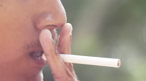 Close-up of a man lighting a cigarette and inhaling. Stock Footage 62854247