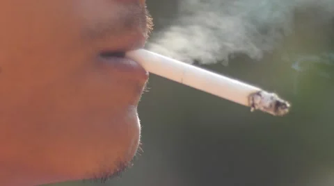 Close-up of a man lighting a cigarette and inhaling. Stock Footage 62854275