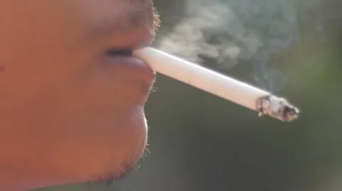 Close-up of a man lighting a cigarette and inhaling. Stock Footage 62854296
