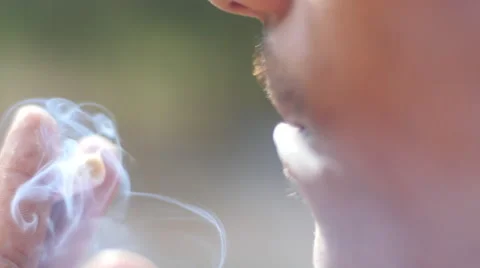 Close-up of a man lighting a cigarette and inhaling. Stock Footage 62854905