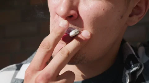 Close up man lighting cigarette in checkered flannel shirt Stock Footage 307054099