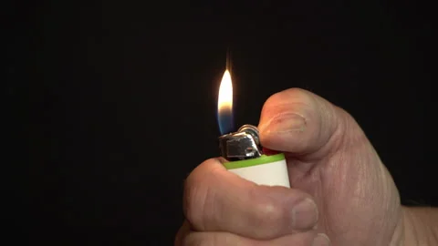 Close up of a man lighting a cigarette lighter Stock Footage 221148290