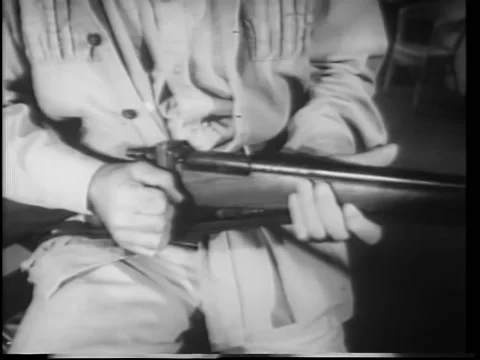Close-up man loading rifle Stock Footage 260248954