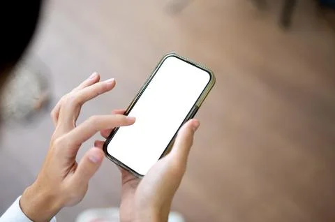 Close up man looking and touching on white screen phone in hand sitting ind.. Stock Photos