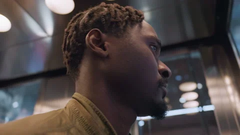 Close Up of Man Looking Around Inside Moving Elevator Stockbeeldmateriaal 319919646