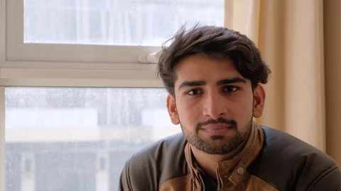 Close up of a man looking at camera and taking instructions off camera Stock Footage 101286132