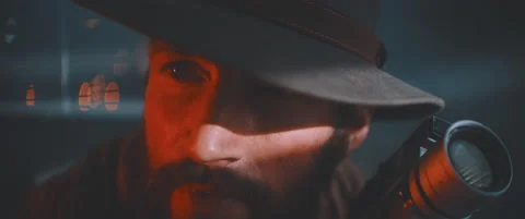 Close up of man looking into camera holding vintage camera Stock Footage 203567683