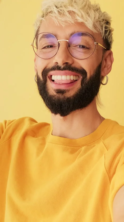 Close-up of man looking at camera making video call, waving in greeting isolated 스톡 동영상 255964387