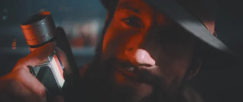 Close up of man looking into camera smiling and holding vintage camera Stock Footage 203567748