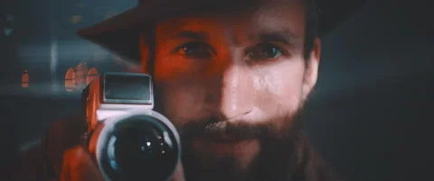 Close up of man looking into camera smiling and holding vintage camera Stock Footage 203568021