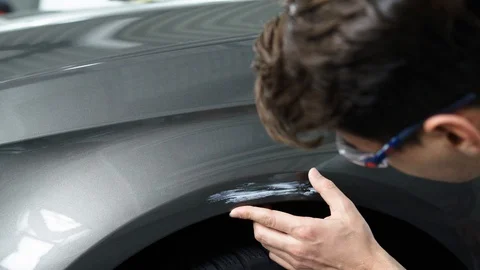 Close-up Of A Man Looking At Damage On A Car Vídeo Stock 129398517