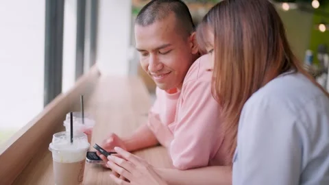 Close-up of a man looking at his lover using a smartphone to surf the internet. Stock Footage 265143269