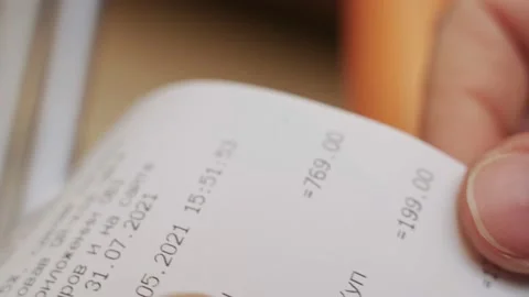 Close up of a man looking at a receipt from a construction store Tracking Stockbeeldmateriaal 155297391