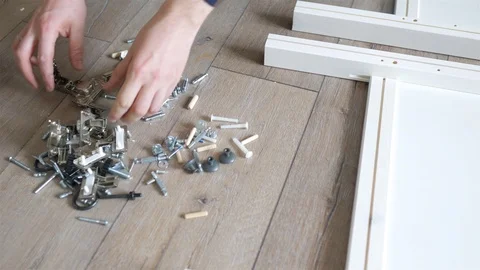 Close-up man looking for the right part for the cabinet Video stock 108299219