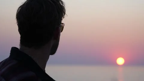 Close up of a man looking at te sunset  Stock Footage 337541907