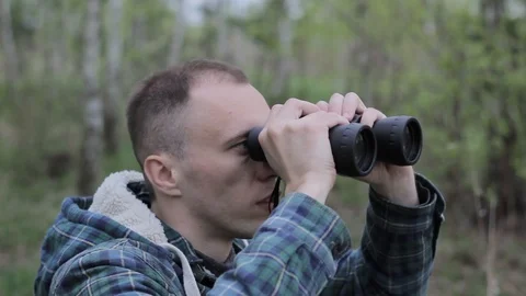 Close up of a man looking through binoculars, outdoors. Stock Footage 88910379