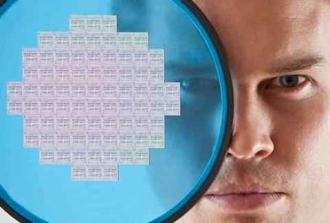 Close up of man looking through computer chip Stock Photos