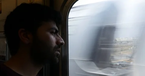 Close-up of man looking through window and listening to music while travelling Stock Footage 120076236