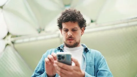 Close-up, man looks at google map on mobile phone and looks around on moder.. 스톡 사진